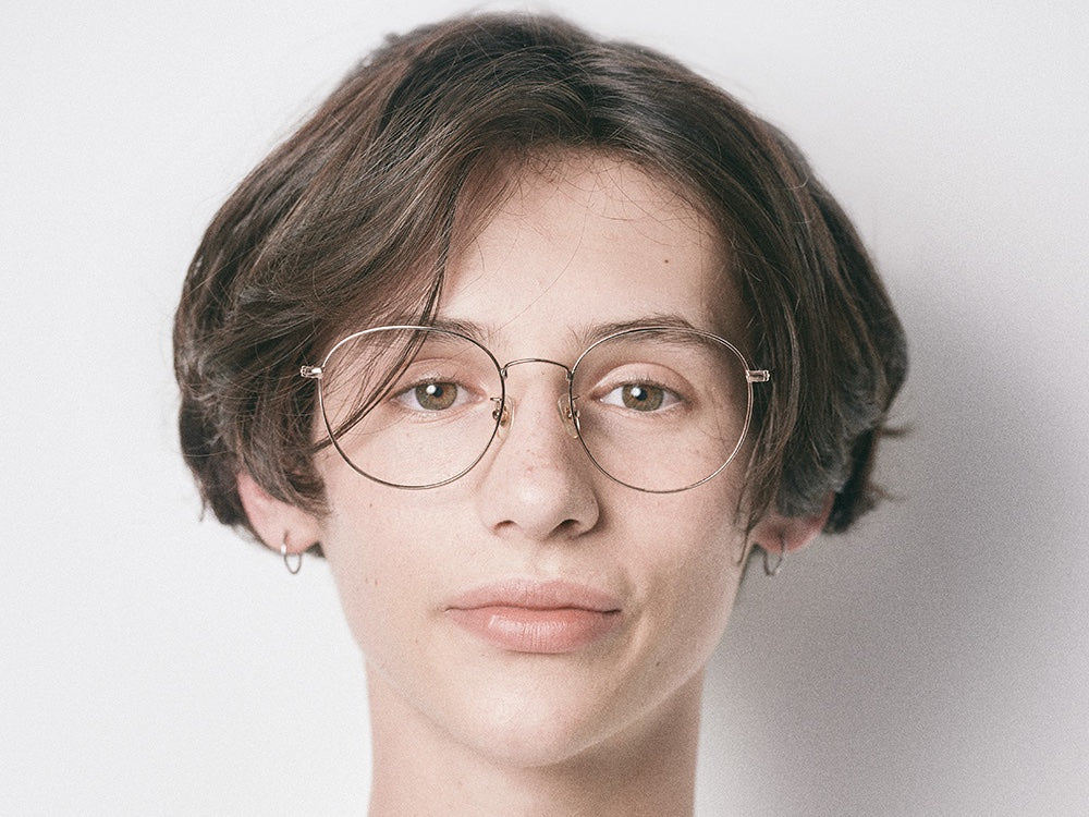 Person wearing NYBK G. Glen Cove M33 Rose Gold Glasses